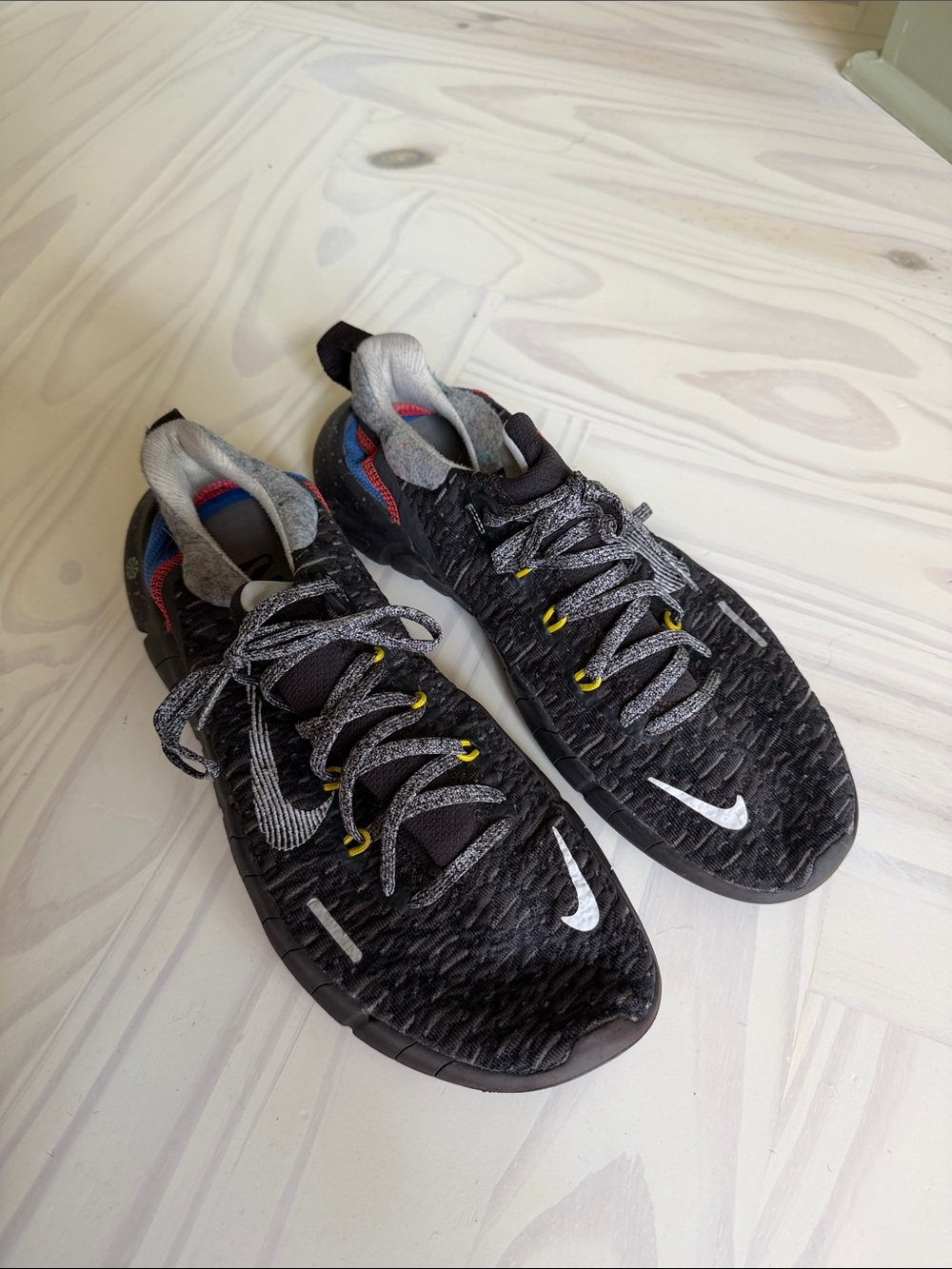 Nike Black Athletic Shoes with White Swoosh and Yellow Eyelets